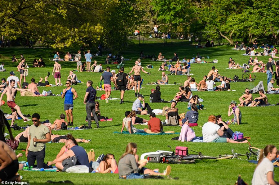 As the weather gets warmer, crowds form in public parks, defying the stay-at-home order