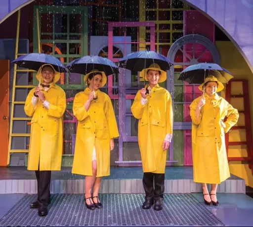 Cast members of the Upper School musical in 2019, Singing in the Rain.