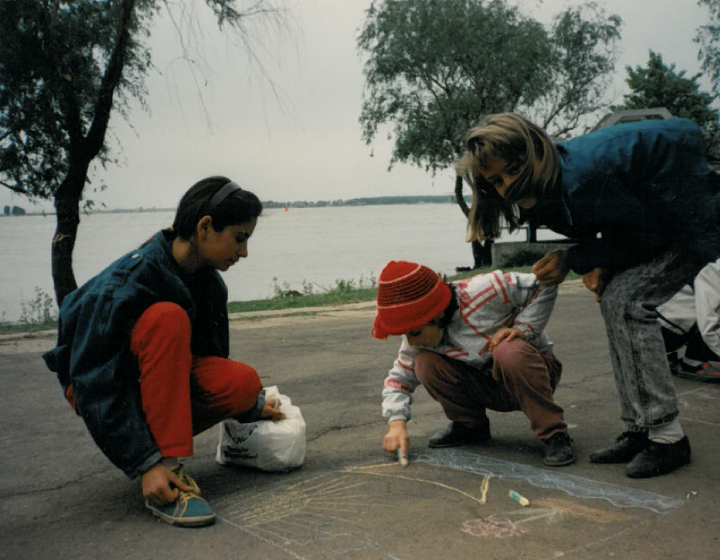 Ms Stephens taught US History and English as a second language while she was in post-communist Romania. Here her students are volunteering with orphans.