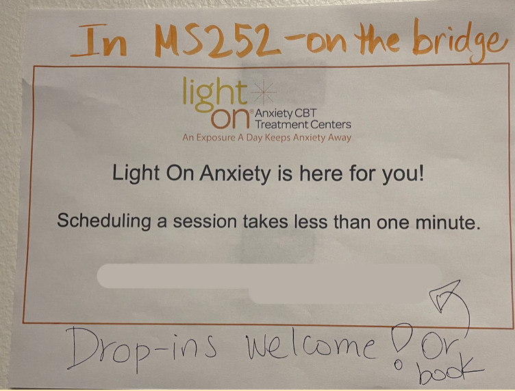 A sign advertising the Light on Anxiety service outside Ms. Knoche’s office.
