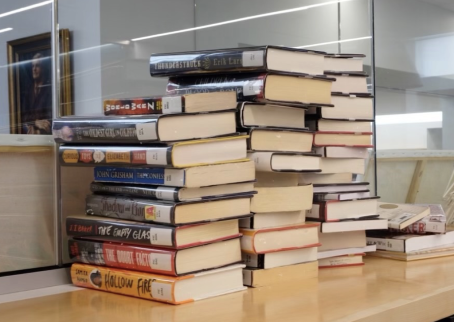 A stack of books in the Upper School Learning Commons awaiting sorting.