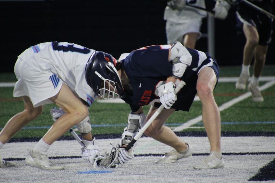 Collin Dwyer 22 seen battling for a faceoff in a lacrosse game