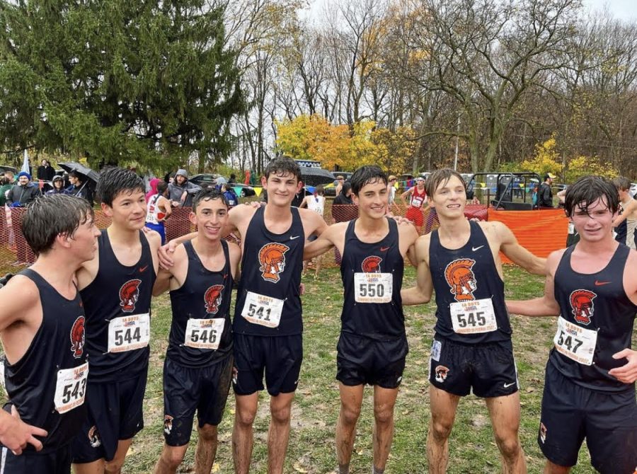 The varsity boys cross country runners, damp but joyous, celebrate their success at the State meet.