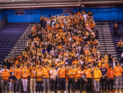 Latin students gather in DePauls bleachers, livening the navy rows with splashes of orange.