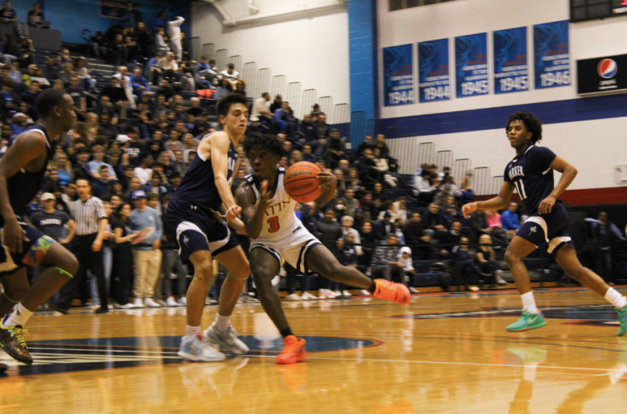 Junior Ryan Mbouombouo breaks through Parkers tight defense in attempt to score a point for the Romans.