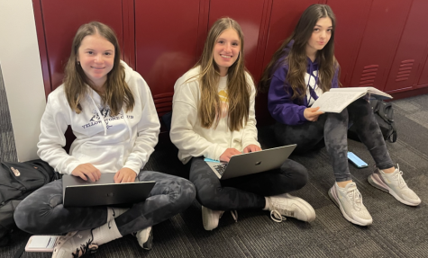 Freshmen Elle Hodes, Elena Tognarelli, and Darina Koedjikova study unmasked in the fourth floor locker bay.