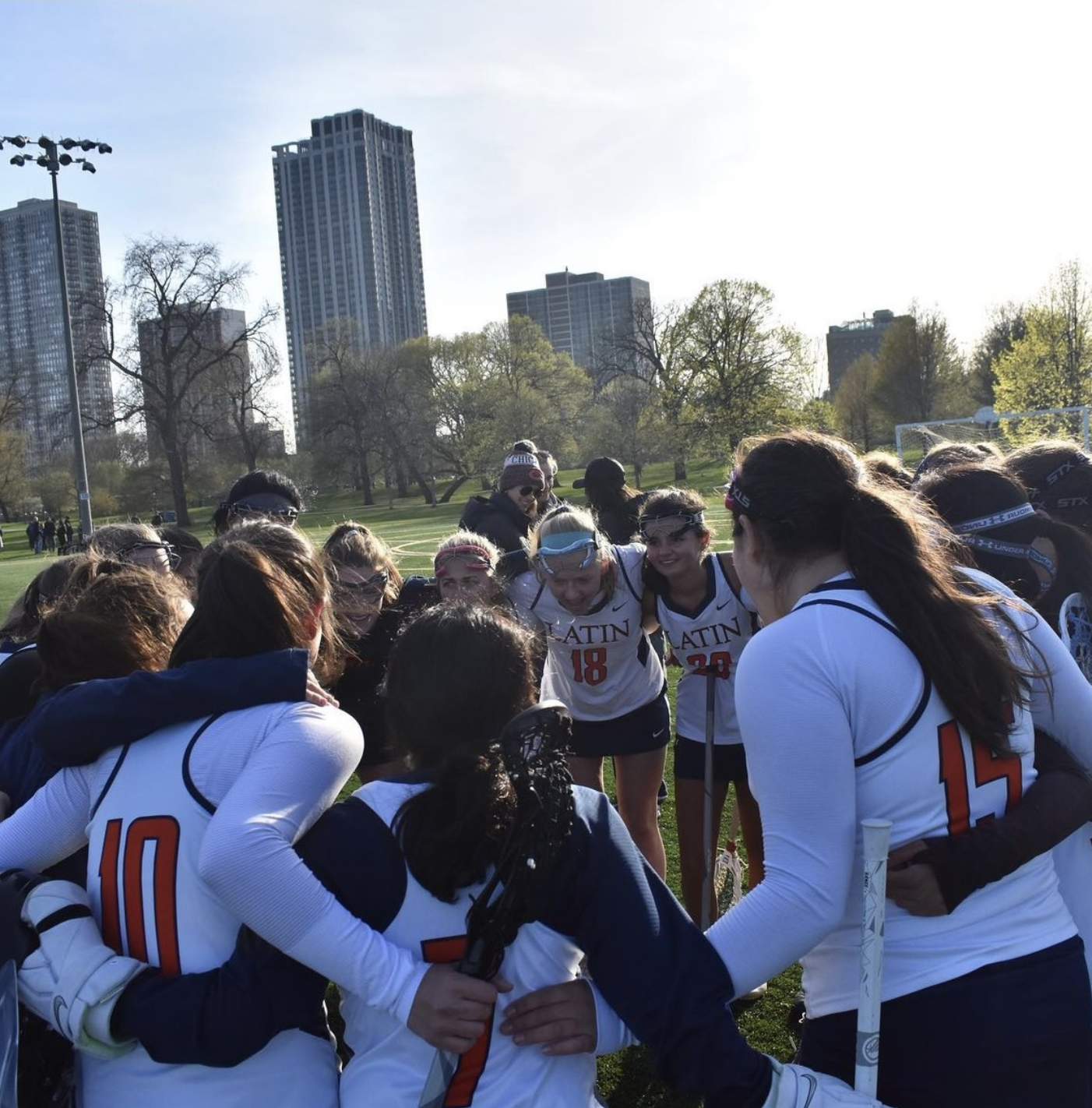 Latins varsity girls lacrosse team huddles during a game against Regina Dominican.