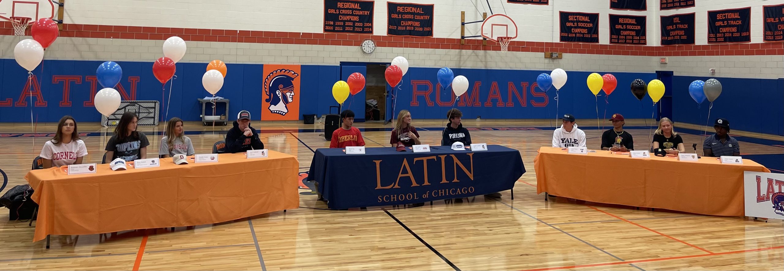 Senior athletes gather in Latins Field Gym to commemorate their college athletic commitments.