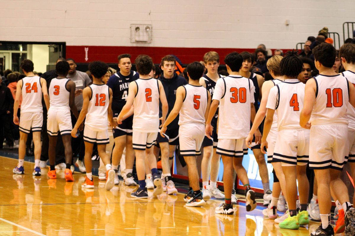 Varsity boys basketball team shakes hands with Parker team after annual Latin-Parker game at DePaul.