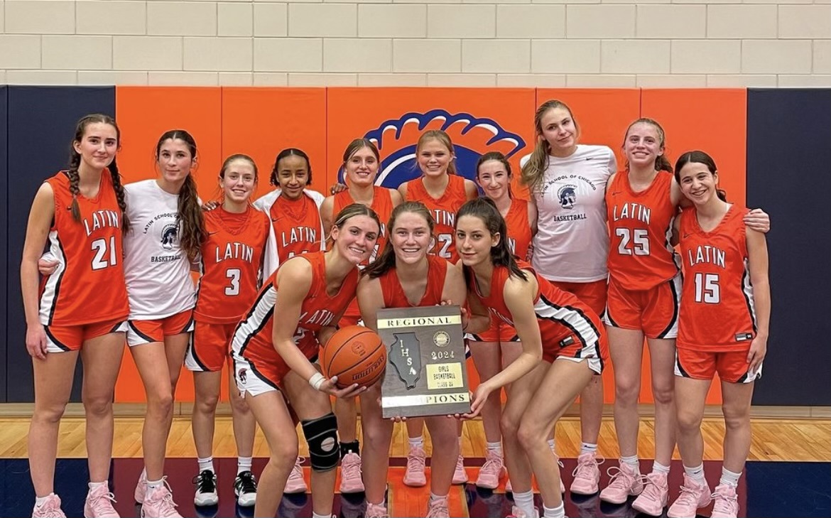 The varsity girls basketball team poses with their regional championship award.