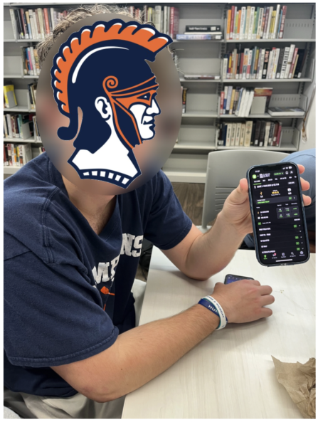 Seated atop the Learning Commons, a Latin senior uses DraftKings to place sports bets. 