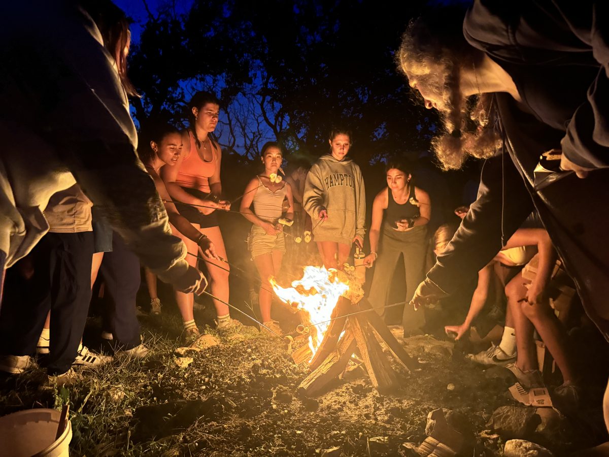 Seniors roast marshmallows on their retreat.