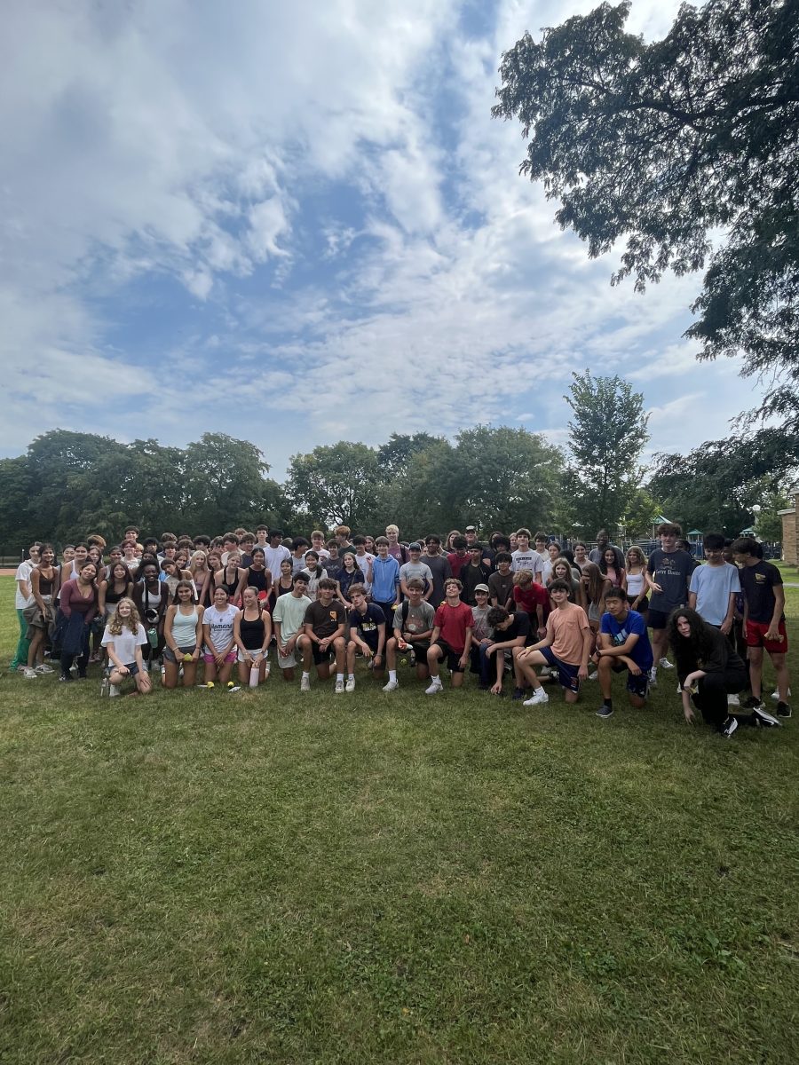 Students pose for a grade level picture after completing their mulching service activity.  