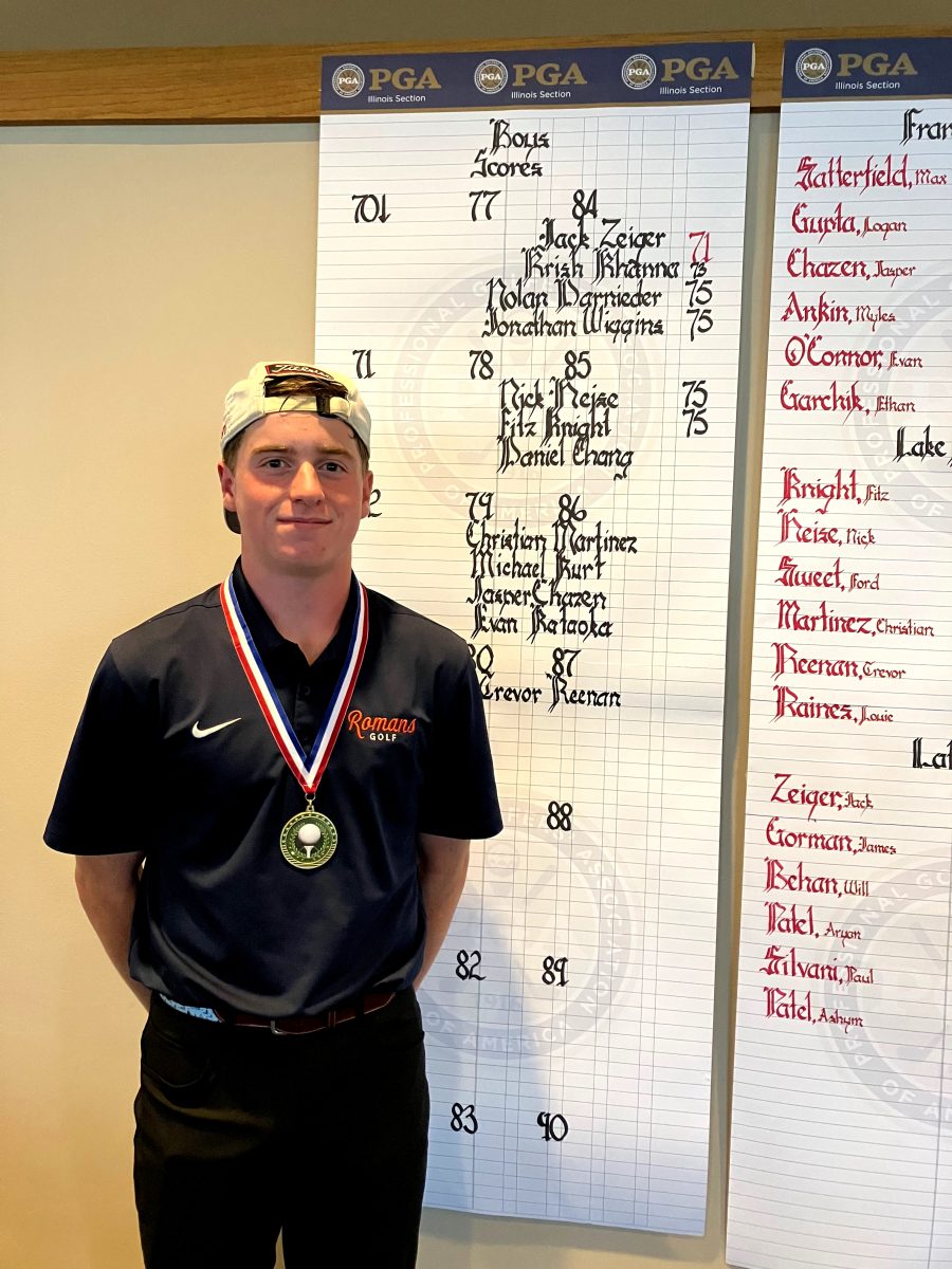 Jack Zeiger wears his first place medal after a rainy day on the course.