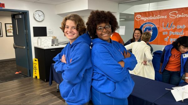 Seniors Evan Stark (left) and Mel Butler (right) pose back to back with their new Latin sweatshirts.