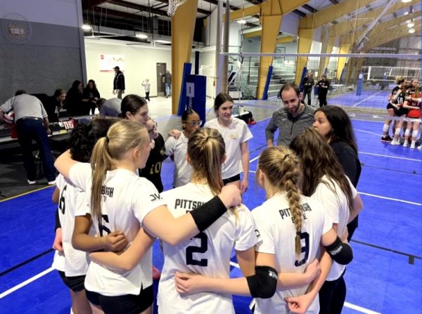 Katie Johnson, on the right, coaching volleyball with her previous team last year