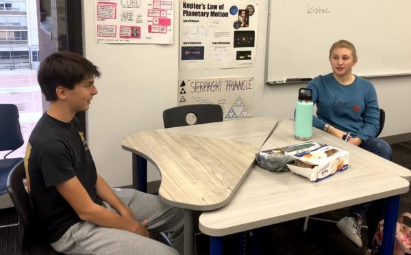 Junior Gillian Herman (right) and sophomore Theo Garino in discussion during affinity time.