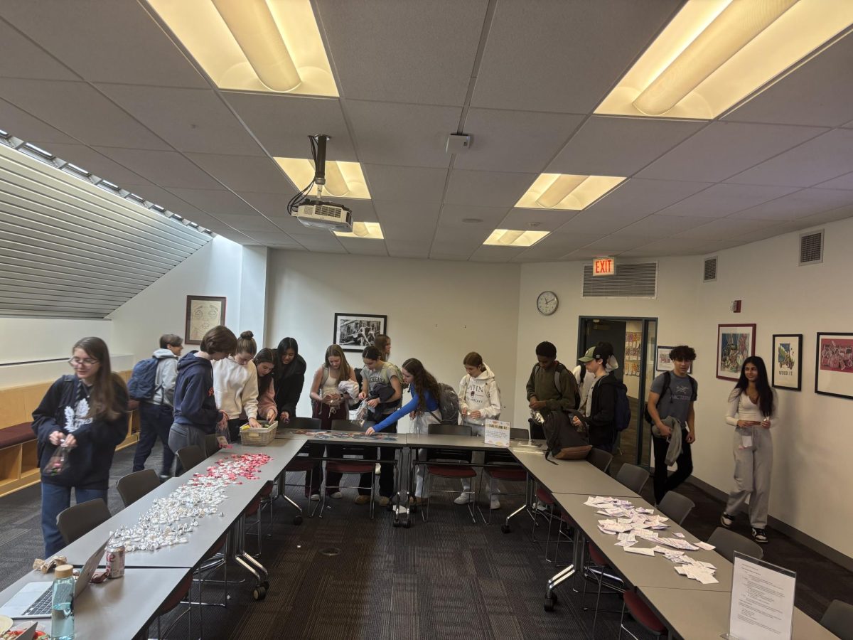 Students gathered around the tables to choose their favorite fidgets and candies.

