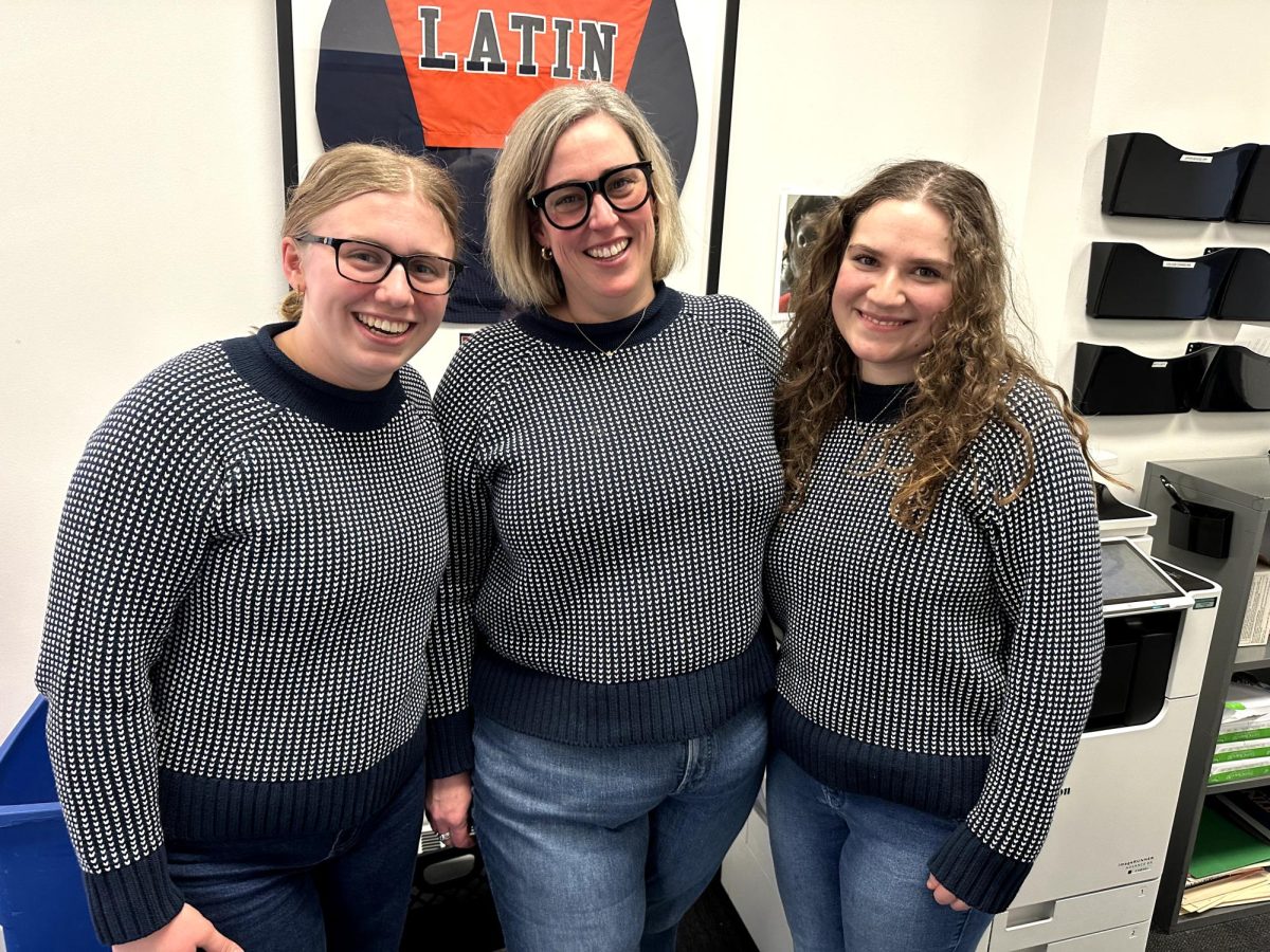 Carla McSweeney, Ninth and Tenth Grade Dean Bridget Hennessy and senior Lucy Baer wearing matching sweaters.