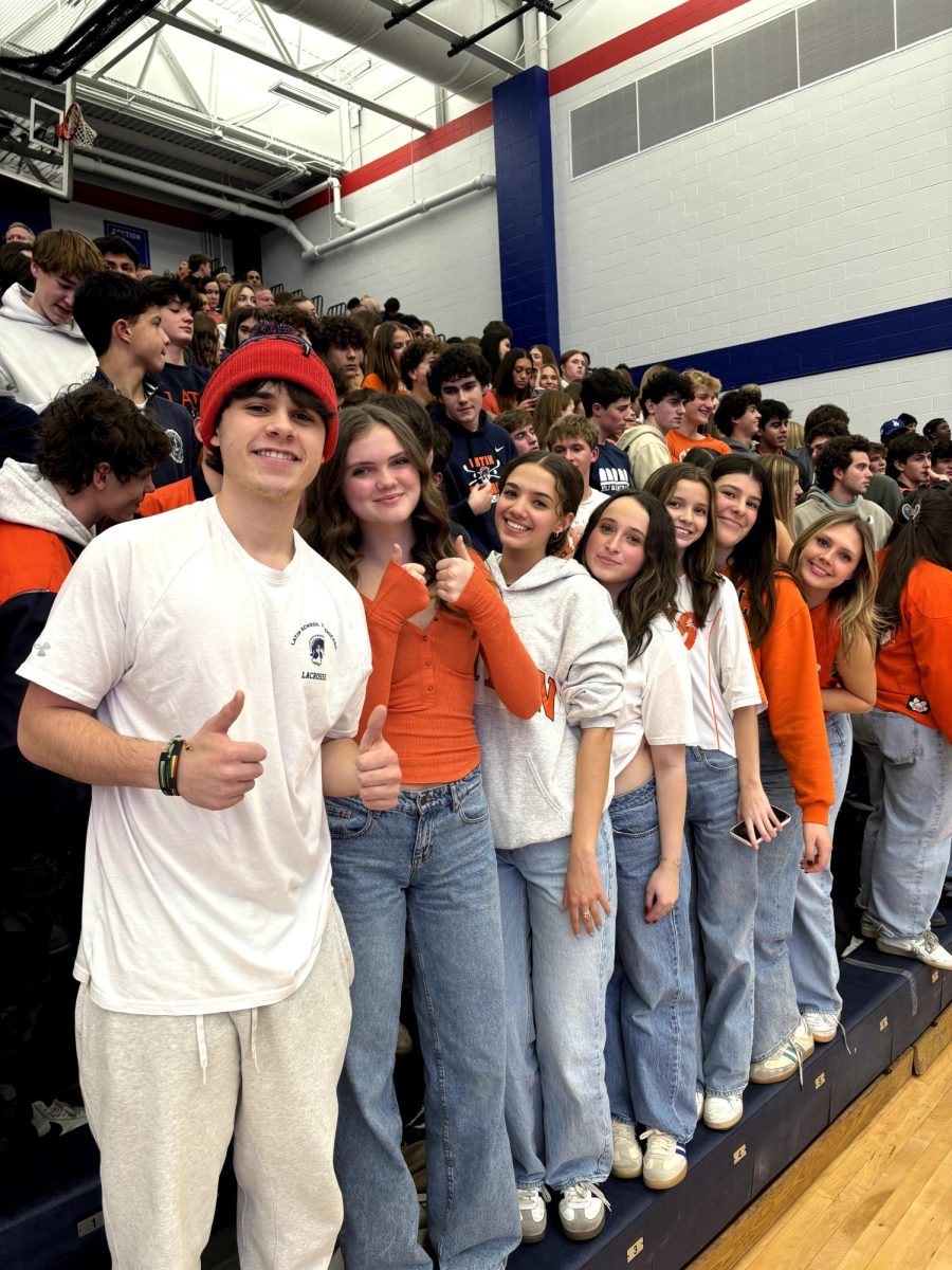 Latin seniors Michael Kotcher, Daley McDermott, Izzy Weinberg, Zoe Hessell, Eva Lapiere, Juliette Katz, and Mimi McCrea (left to right) pack the stands at the Big Game.