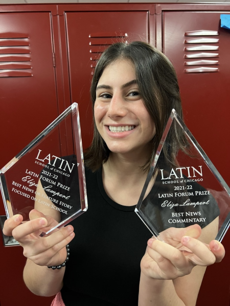 Eliza Lampert '24 holding up two awards, Best News or Feature Story and Best News Commentary, won at Latin's 2022 Forum awards.