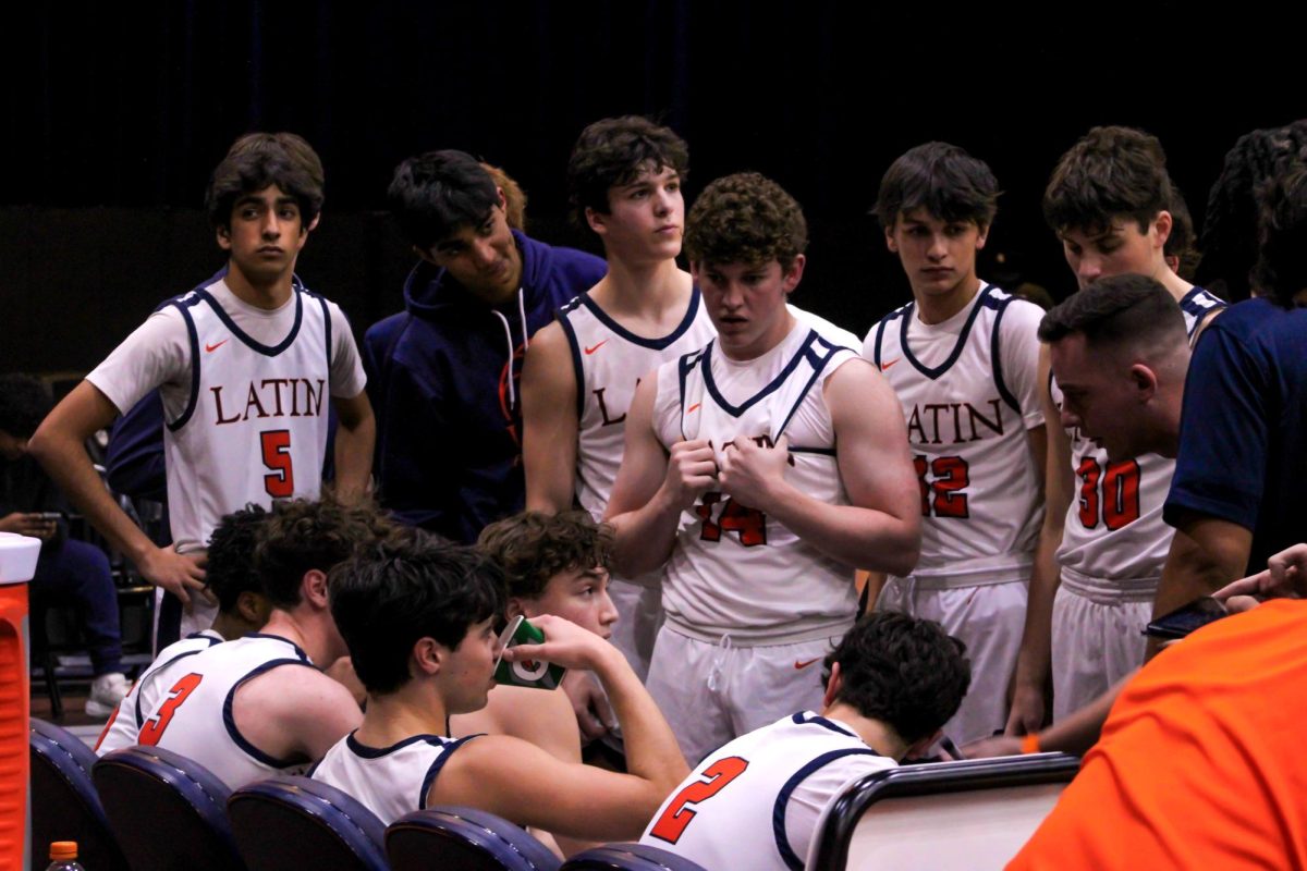 Players huddling together moments before exiting the court during halftime.