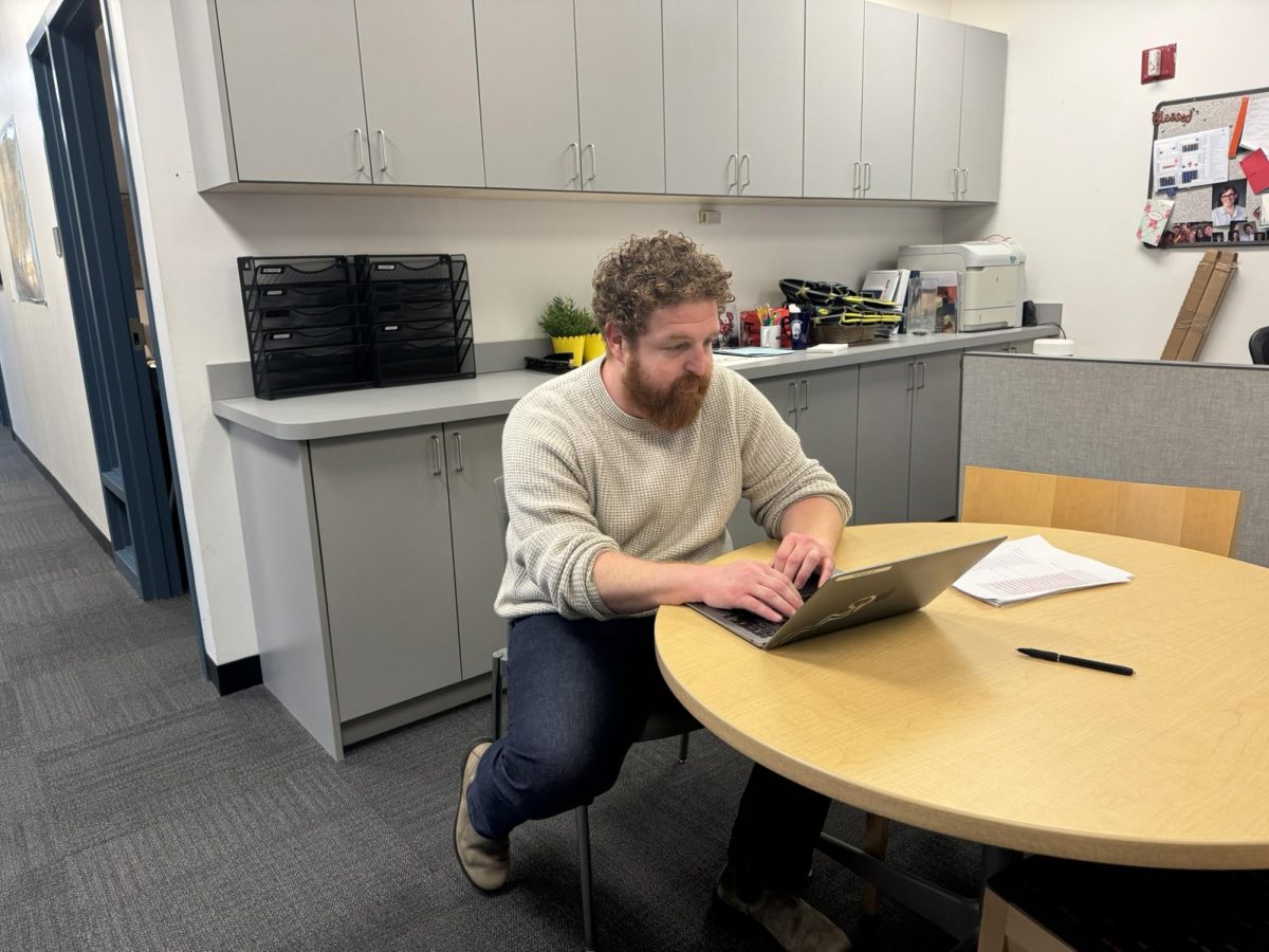 Lenny Goldman working in the Upper School Office.