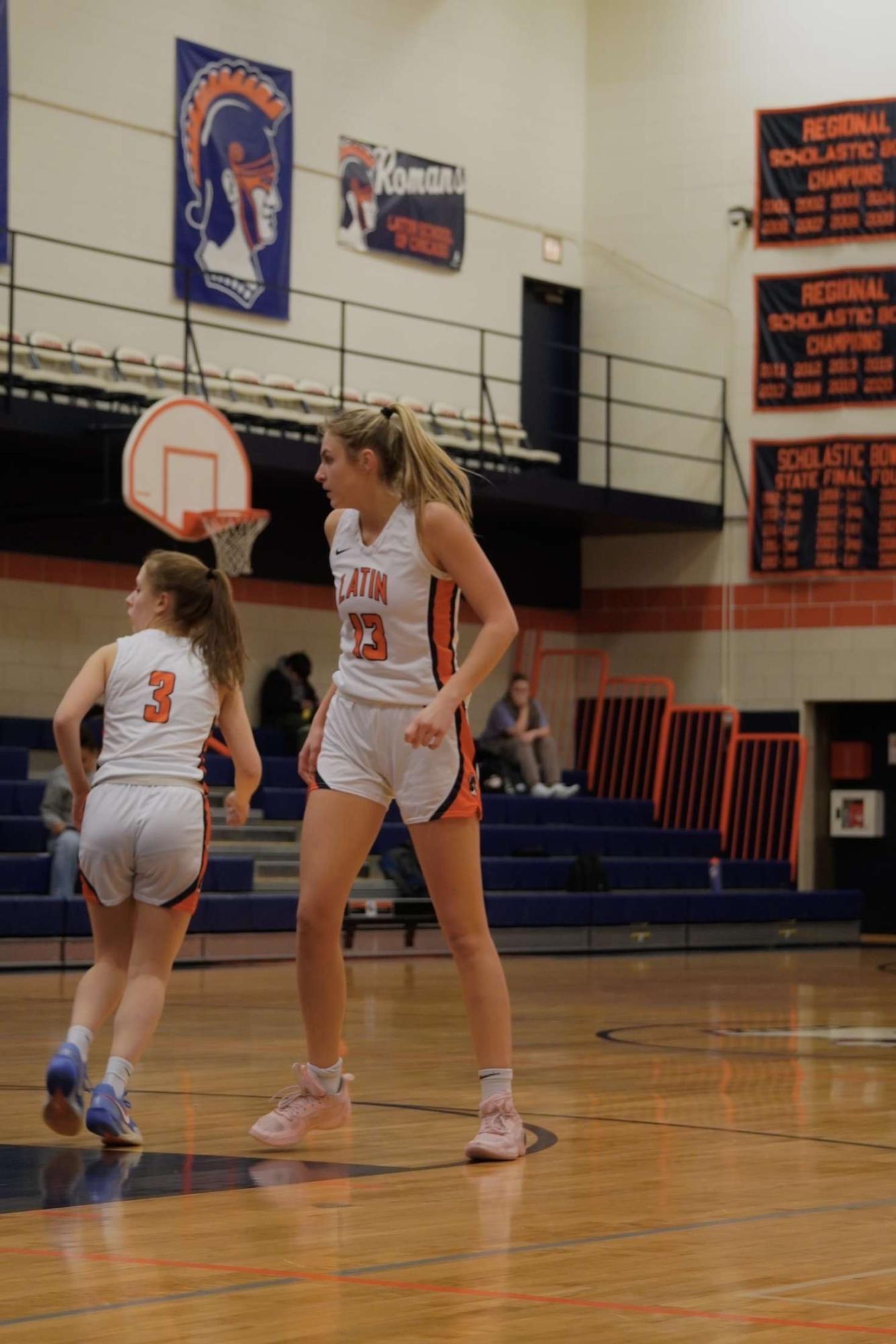 Ellie during a varsity girls basketball game in the Latin gym.