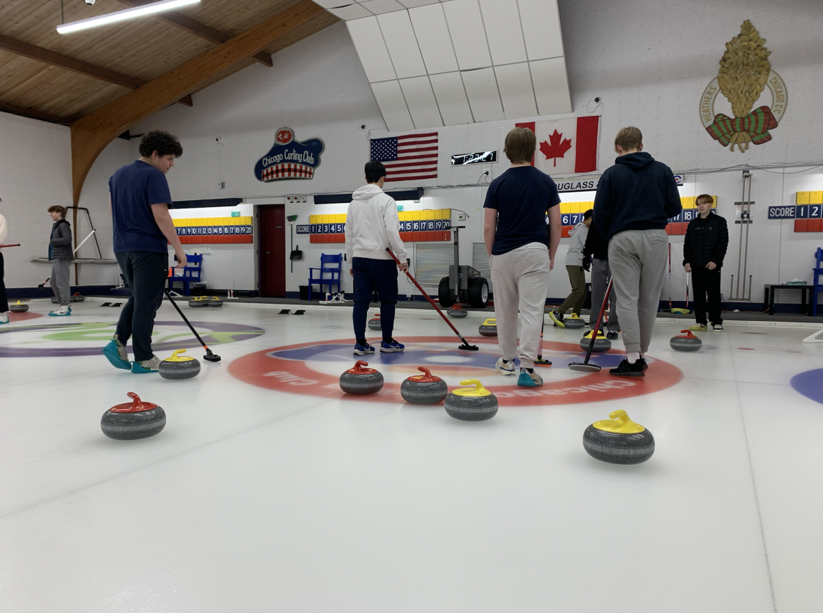 Students in the Curling Project Week group judge the score of a practice end during Wednesday's on-ice practice.