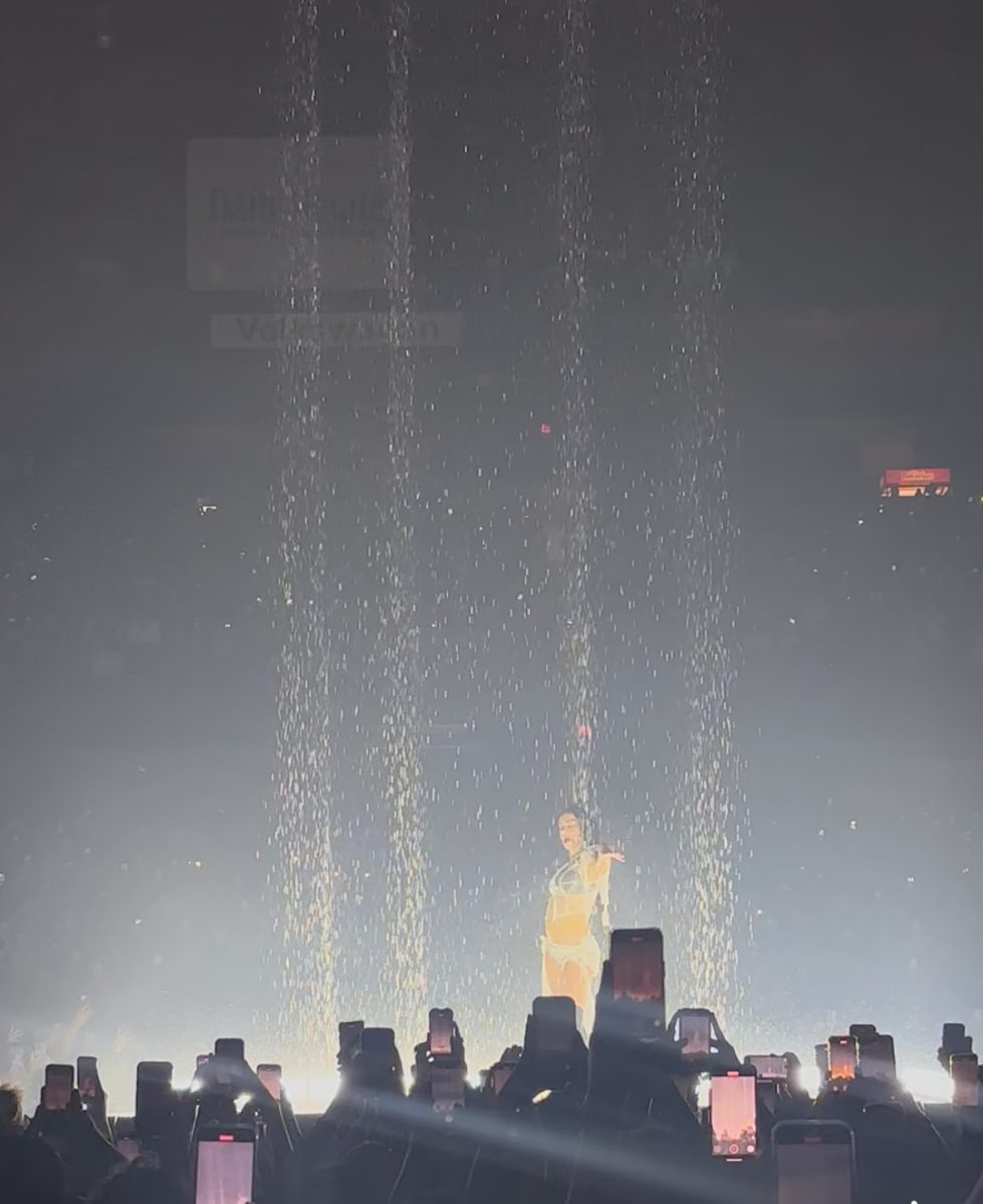 Charli XCX singing “Track 10” while being rained on at the Allstate Arena.