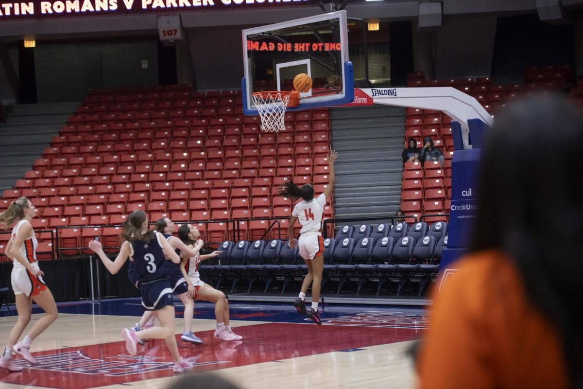 Sophomore Cali King make a layup at the Big Game with the stands nearly empty.