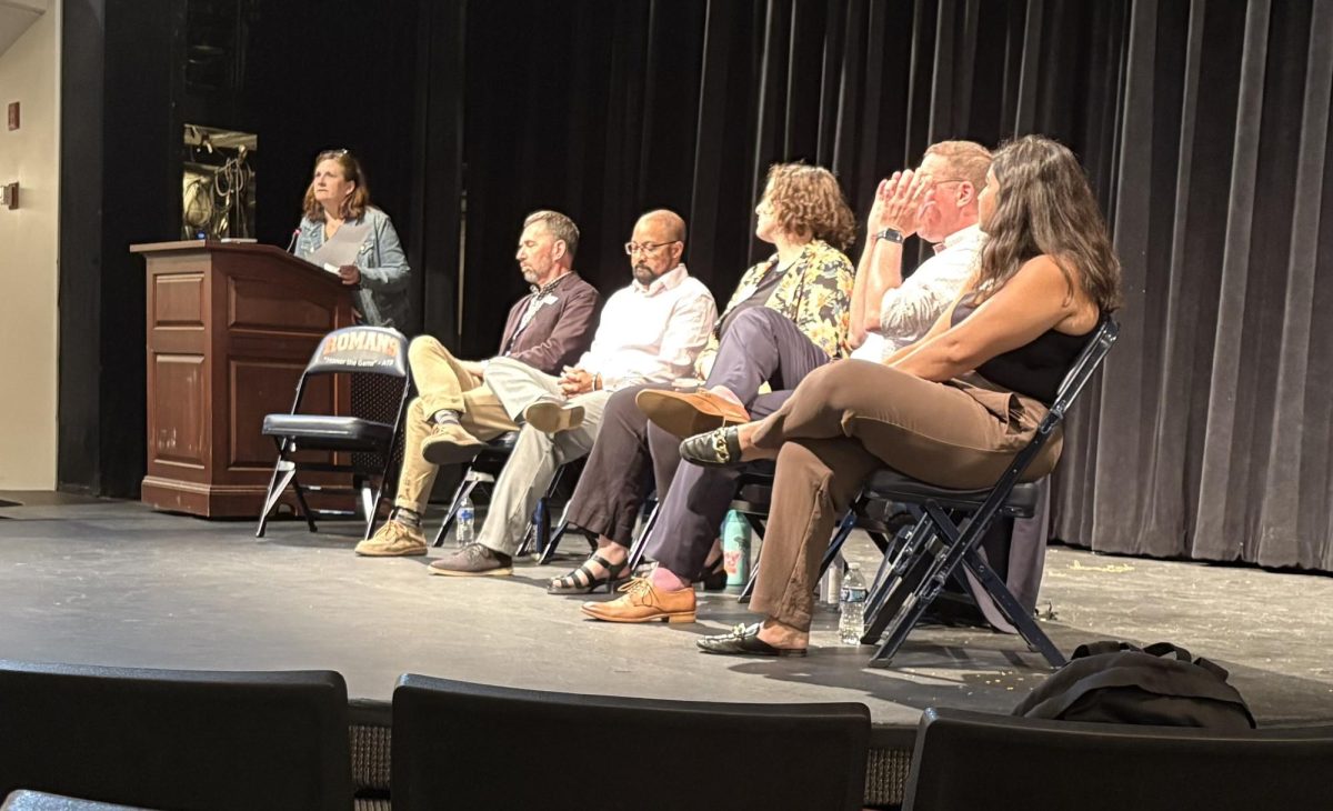 College representatives sit for a panel with students and parents.