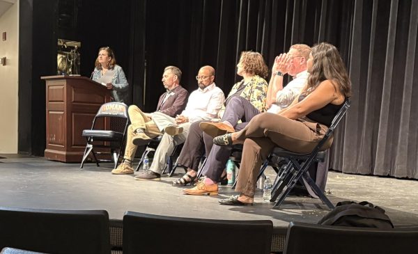 College representatives sit for a panel with students and parents.