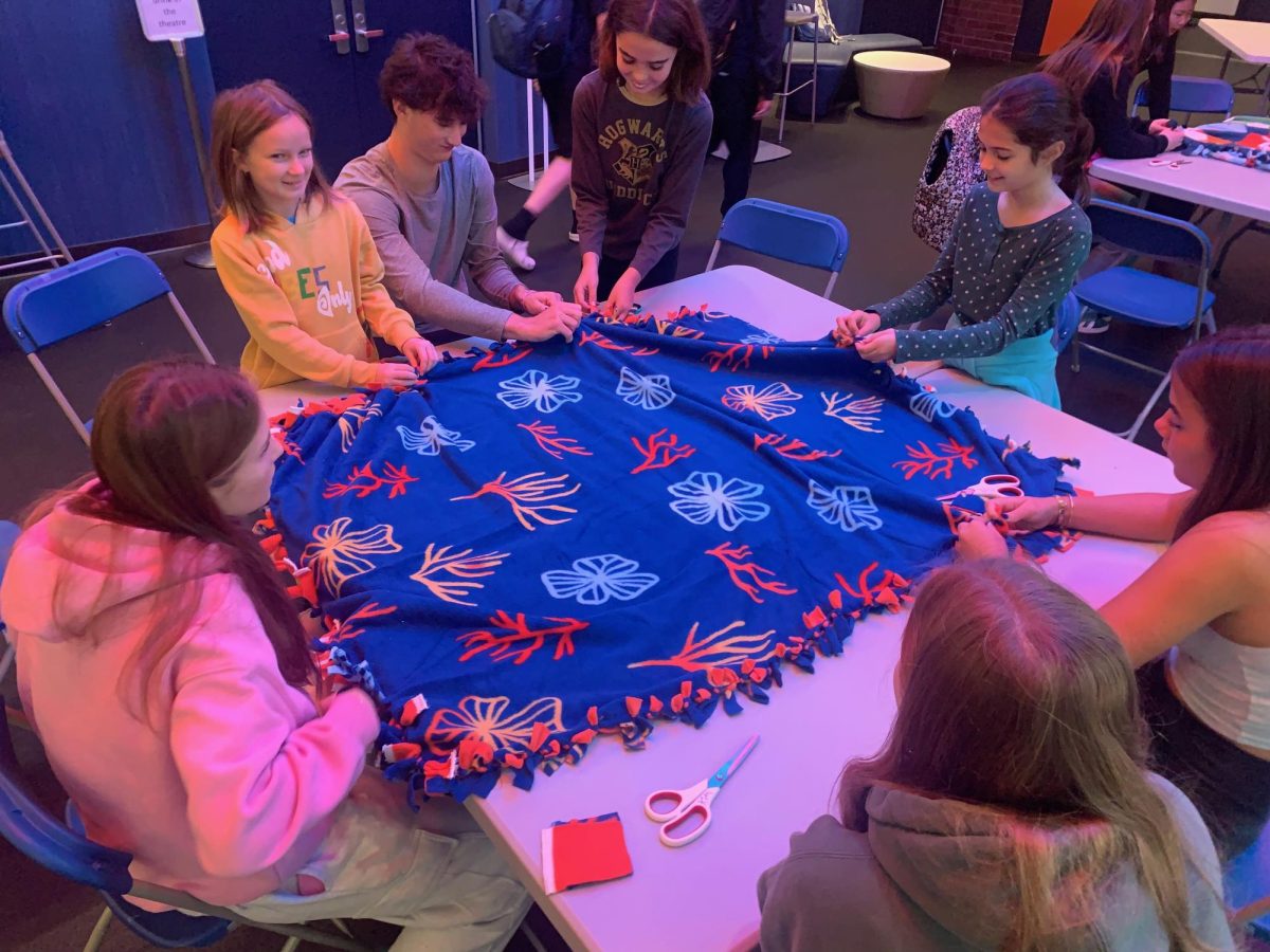 Students make a blanket at an SSLB event.