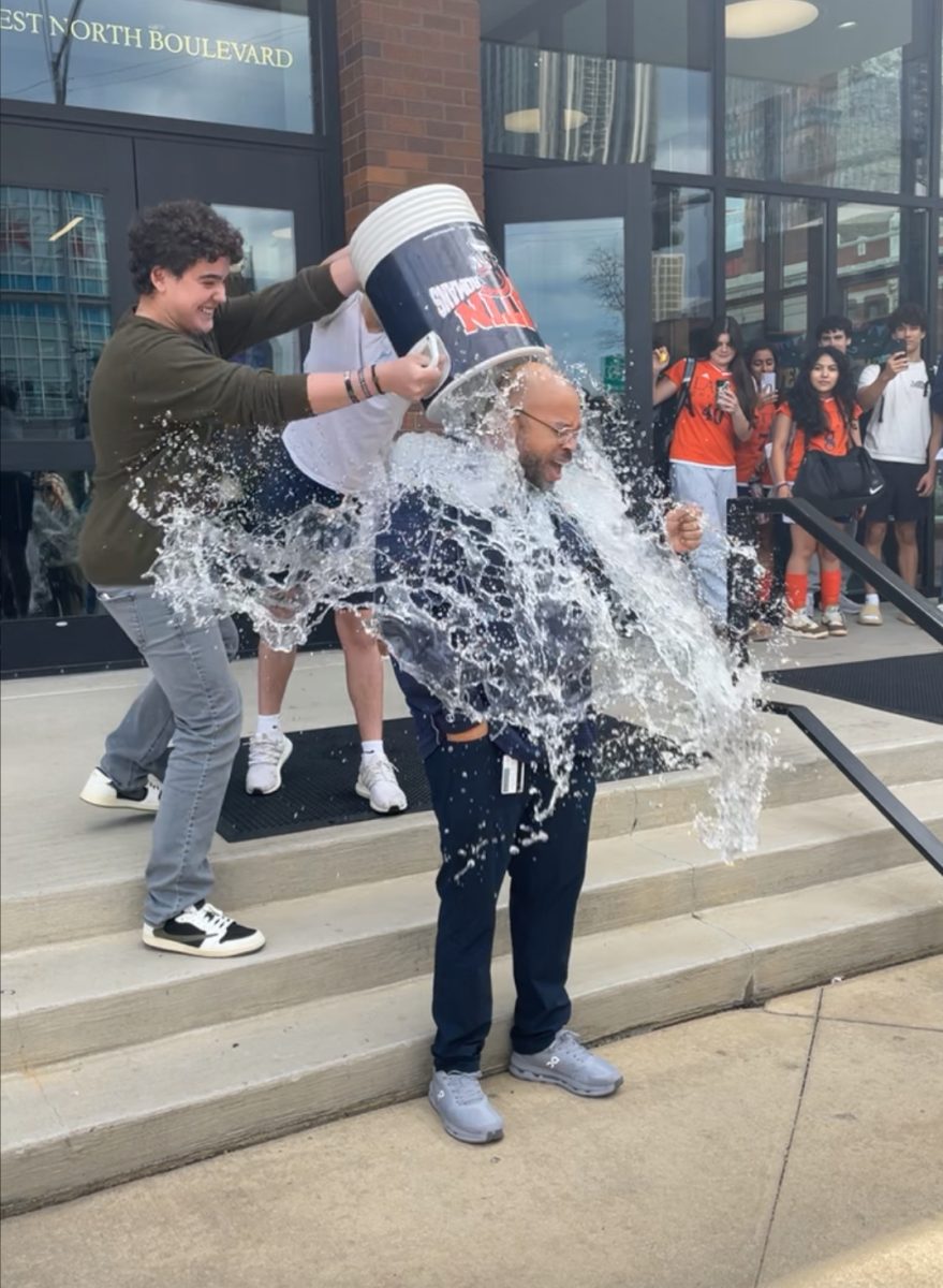 Students dump ice cold water on Assistant Head of School Ryan Allen after he finishes his nominations for the USC "Speak Your MIND" Ice Bucket Challenge