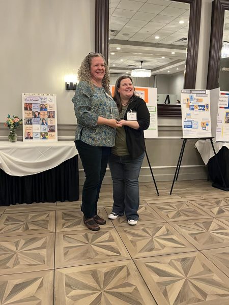 Catherine Curry receiving an award from ACA Illinois CEO Colette Marquardt.