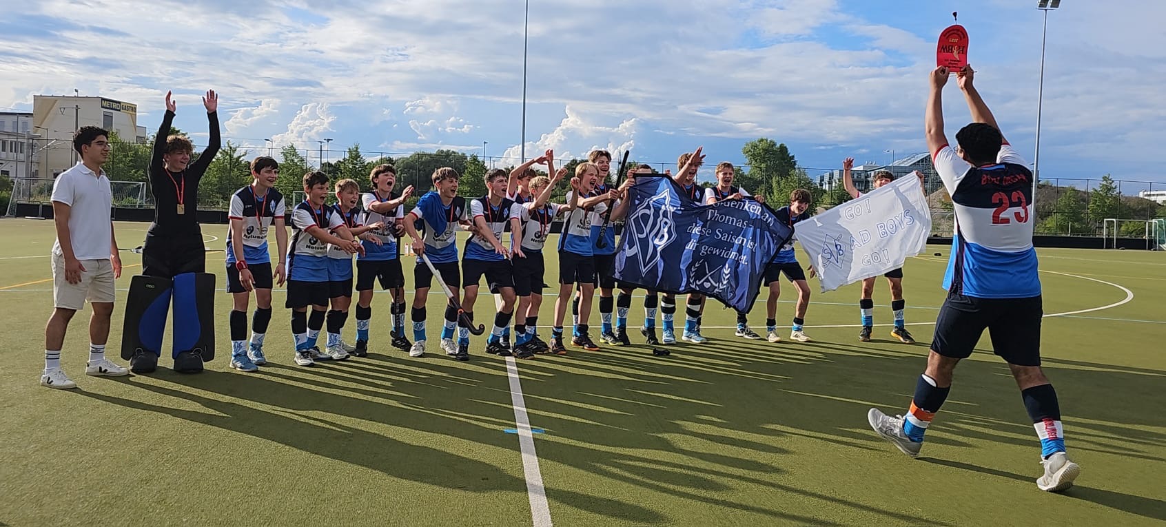 As team captain of SV Böblingen, Kaleb (number 23 with back to the camera holding red trophy) celebrates the championship win with his team.