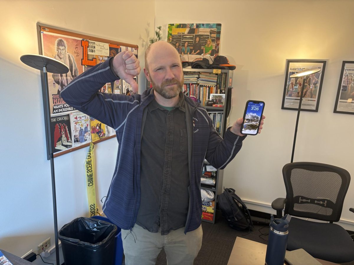 Upper School Director Nick Baer gives a thumbs down to cell phones.