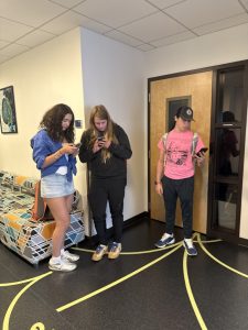 Juniors Pilar Alexander, Oscar Bubel, and Gabe Goldstein on their phones (after school hours, of course).