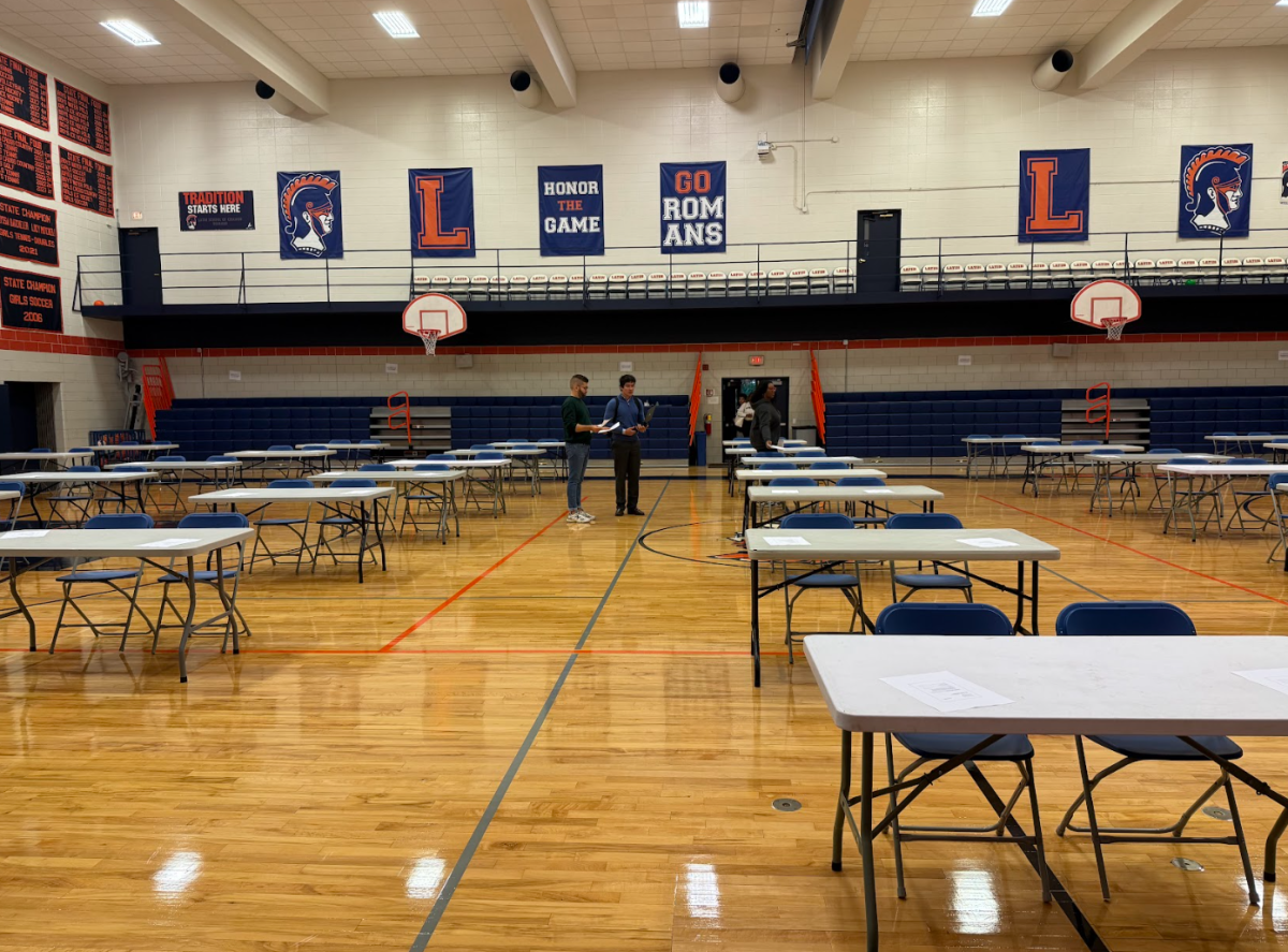 Assistant Director of College Counseling Alex Zotos and junior Alex Stamos prepare for students to arrive for the exam.