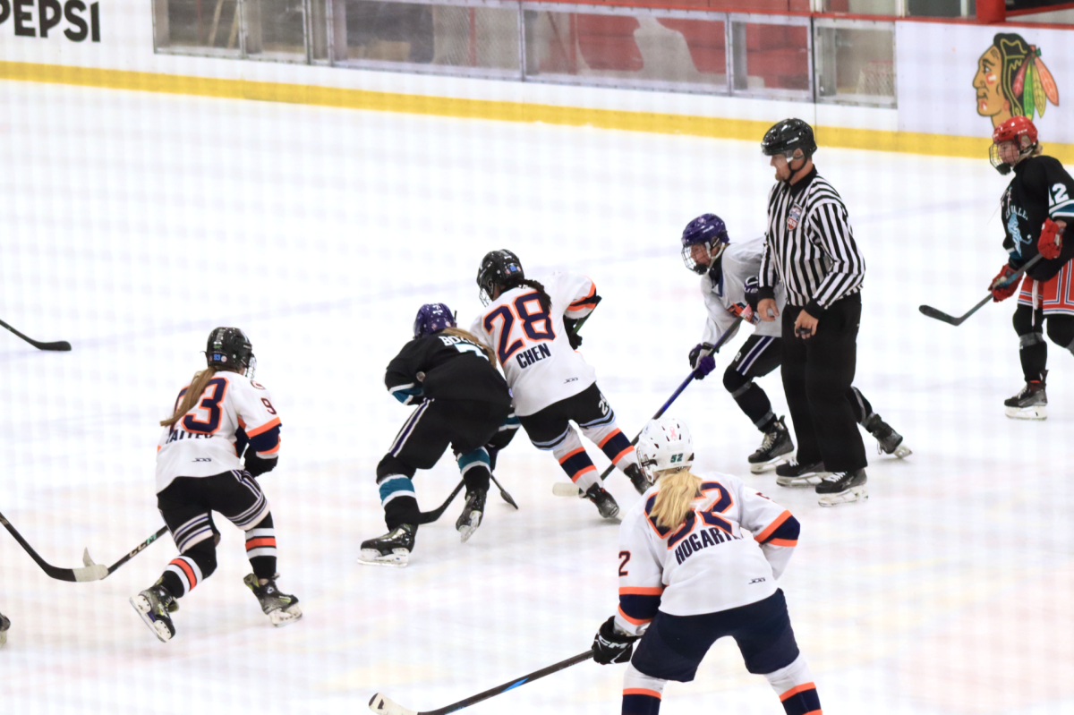 Junior Annie Chen defends the puck from an opposing player.