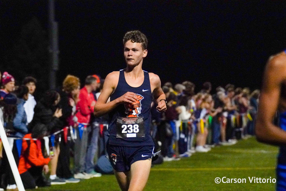 Nico Rastatter crossing the finish line at the Loyola meet.