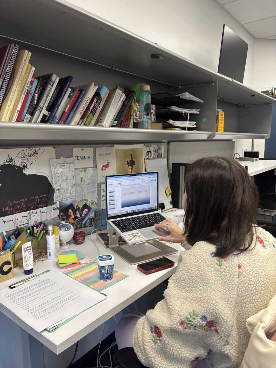 Upper School English teacher Kailey Cole works on presentations for her English class, American Seeker.   