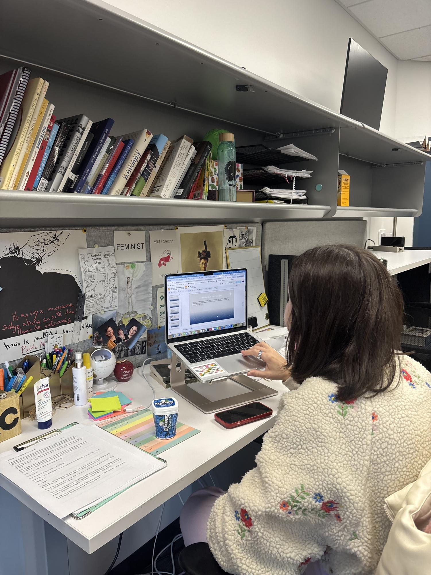 Upper School English teacher Kailey Cole works on presentations for her English class, American Seeker.   
