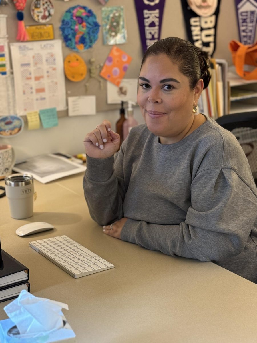Ms. Vela sits at her desk in the College Counseling Office.
