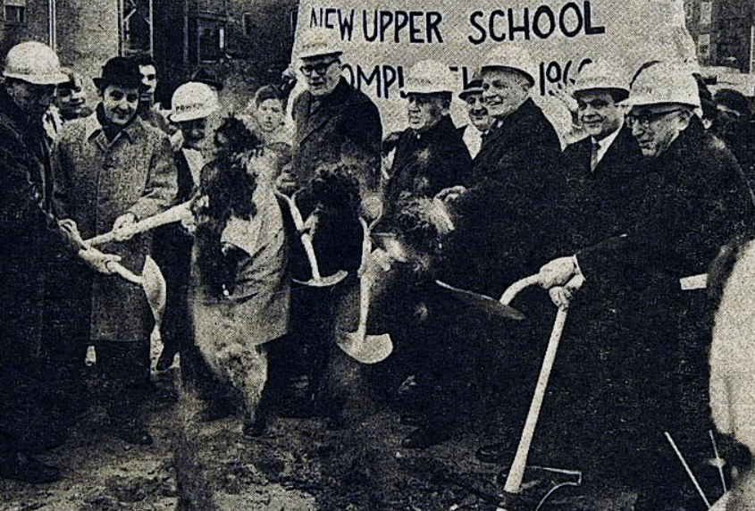 Dirt flies and onlookers stare in disbelief as Mr. Graham, Mayor Daley, and other Chicago V.I.P.'s finally dig in. 
