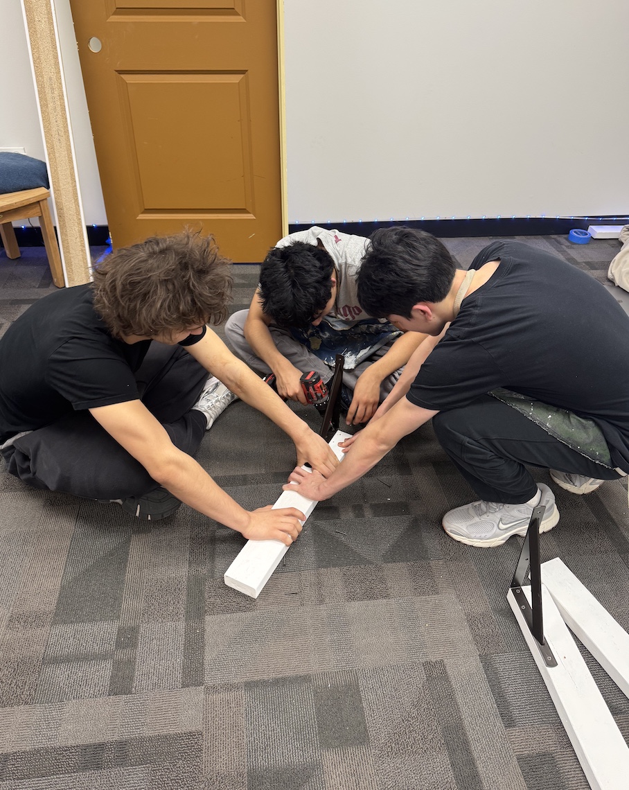 Students construct support for the walls.