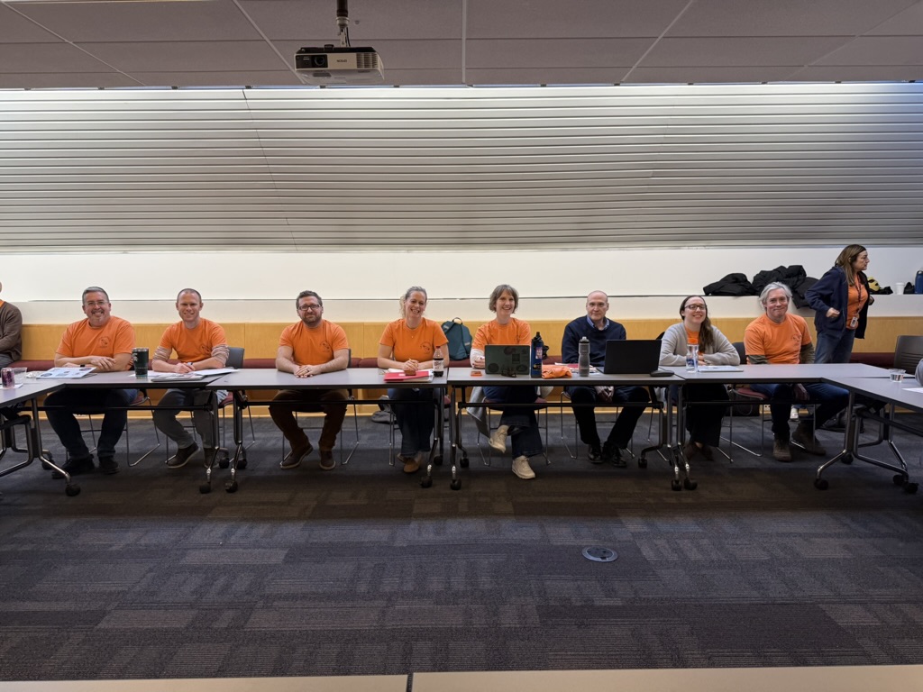 Union members and administrators assemble at the bargaining table in room 411.