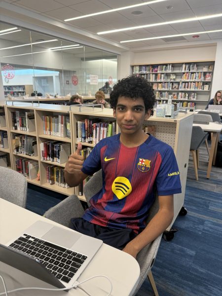 Pedro Espinoza sits in the quiet area of the Learning Commons, finishing his homework during a free period.