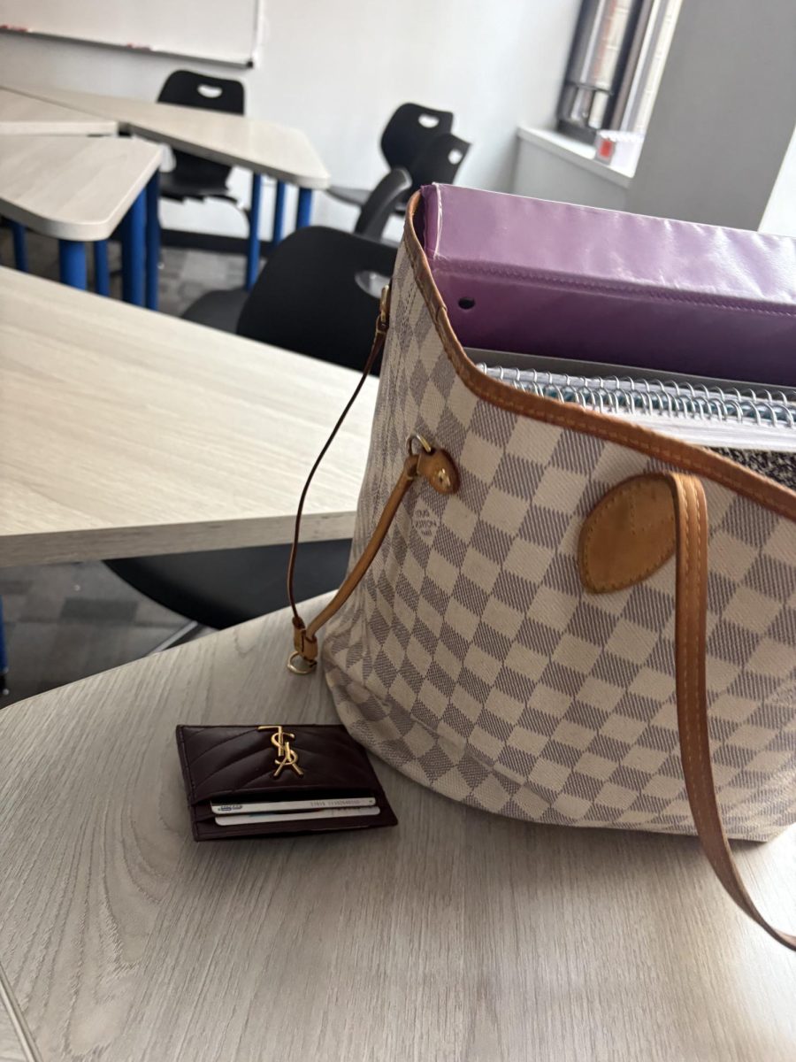 Louis Vuitton bag and Yves Saint Laurent wallet seen at school.